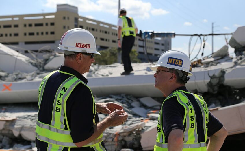 Two inspectors from the National Transportation Safety Board discuss the collapse of a pedestrian bridge at Florida International University in March 2018. The board released its findings October 22, citing design flaws as a major cause. Photo courtesy of NTSB