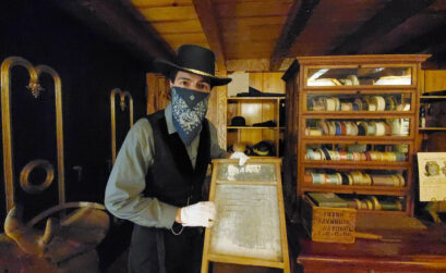 As Mr. Jones, proprietor of Mr. Jones’ General Store, Deron Sun Eagle touts the virtues of this washboard for pioneers needing to wash their clothes. The general store is part of two new Museum LIVE! exhibits at the Corpus Christi Museum of Science and History. Photo by Jane Kathleen Gregorio