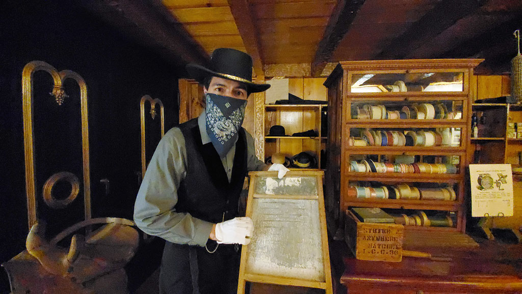 As Mr. Jones, proprietor of Mr. Jones’ General Store, Deron Sun Eagle touts the virtues of this washboard for pioneers needing to wash their clothes. The general store is part of two new Museum LIVE! exhibits at the Corpus Christi Museum of Science and History. Photo by Jane Kathleen Gregorio