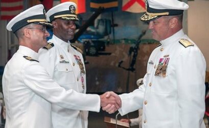 Commander Navy Medicine East, Rear Adm. Terry J. Moulton (right), congratulates Capt. Guido F. Valdes during a change of command ceremony aboard USS Lexington Aug. 27, 2015. Valdes becomes the 38th commanding officer of Naval Health Clinic Corpus Christi in its 74 year history after relieving Capt. Jimmy A. Bradley (center), who will transfer to Chief Business Operations Tricare Regional Office-South, San Antonio, Texas. (U.S. Navy photo/Released)