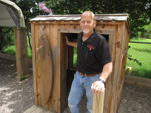 Mark ‘Buzz' Haldeman earned his nickname from his buzz saw-like energy. 'Now it’s more of a ‘buzzard’ nickname, my friends tell me,' he said with a laugh as he showed off his work in the Annaville Baptist Church playground. Details, such as adding a surfboard to the exterior of a playhouse, are his speciality. Photo by Suzanne Freeman