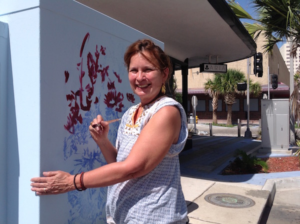 Artist Deborah Males (www.deborahmales.com) transfers a triptych of her recent series "Blessings" onto an electrical box in downtown Corpus Christi. The wildflower scene captures the Aransas Wildlife Refuge after the spring rains. Downton will turn from a gallery to a working studio during Masterpiece in a Day Saturday, Sept. 12. Photo by Suzanne Freeman