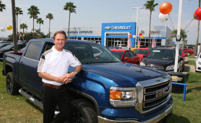 Greg Barton, general manager of Aransas Autoplex in Aransas Pass, with one of his top selling vehicles: the good ol’ Texas Truck! Photo by Carrie Robertson Meyer/Third Coast Photo