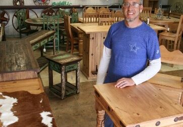 Chris Olsen, owner of The Ranch Rustic Furniture and Home Decor, on the showroom floor at 6429 S. Crosstown Expressway. Photo by Carrie Robertson Meyer/ Third Coast Photo