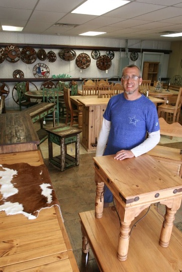 Chris Olsen, owner of The Ranch Rustic Furniture and Home Decor, on the showroom floor at 6429 S. Crosstown Expressway. Photo by Carrie Robertson Meyer/ Third Coast Photo