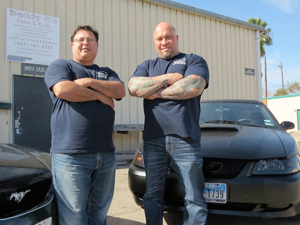 The team at Daddy O’s Paint & Body, owner Roland De La Peña (left) and manager Albert Cantu, show off some of their recent custom work in front of their shop.