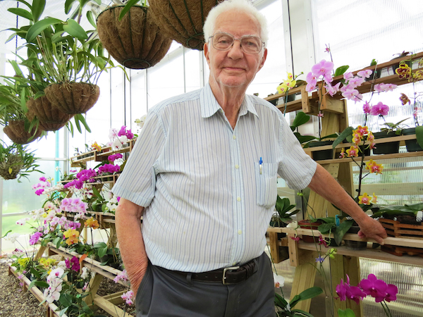 Samuel Jones proudly stands in the newly opened orchid conservatory which is named for him at the South Texas Botanical Gardens and Nature Center. Staff Photo