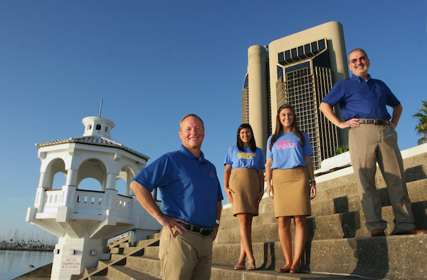 Where downtown meets the sea! The team at the Downtown Management District includes (from left) Terry Sweeney, executive director; Hannah Shaw, merchant and special events coordinator; Sierra Shamblin, arts coordinator; and Allen Albin, finance and operations manager. Photo by Carrie Robertson Meyer/Third Coast Photo