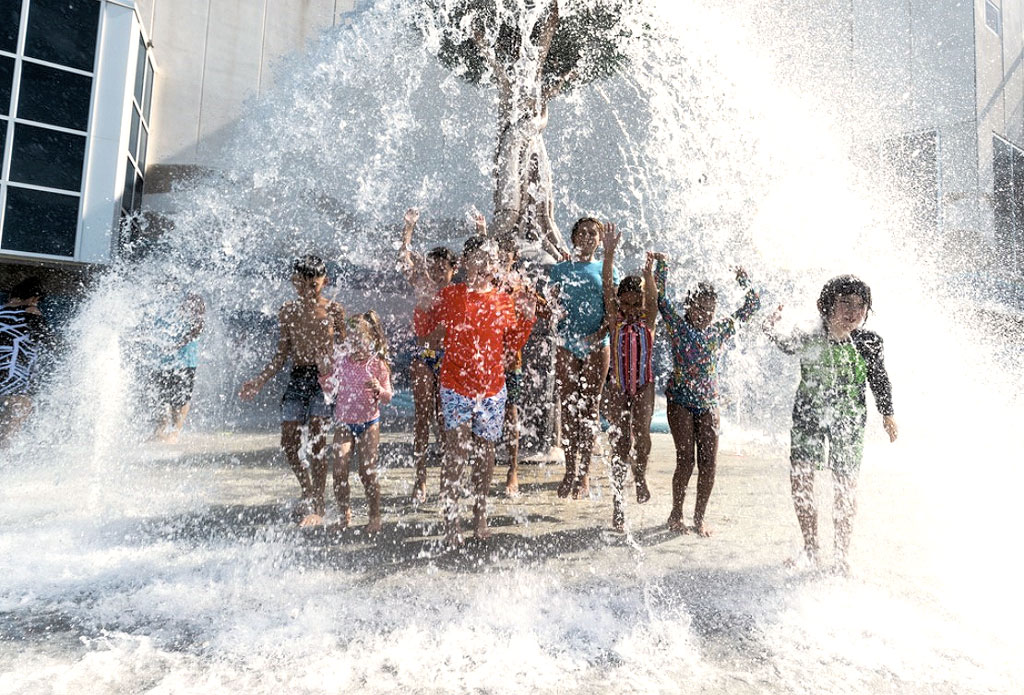 Youngsters beat the heat under the 350-gallon water dump at the Texas State Aquarium’s newly renovated H-E-B Splash Park. Photo courtesy of Texas State Aquarium