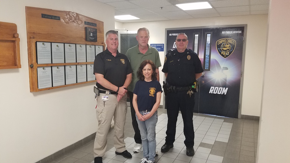 Police volunteer coordinator Tom Brown (left) and Capt. Russell Sherman (right) with volunteers Celeste Hogin and Wayne Bortner at Corpus Christi police headquarters at 321 John Sartain St. in downtown. Photo by Jane Kathleen Gregorio