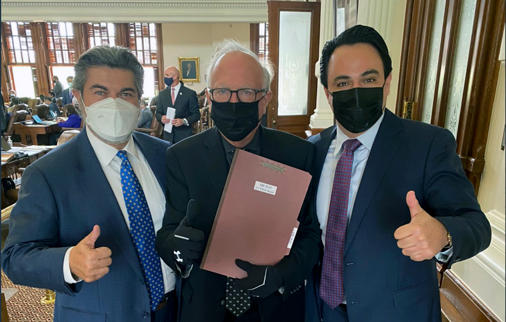 State Rep. Todd Hunter (center) proudly holds onto House Bill 3810, which was approved 146-2 by the Texas House of Representatives. With Hunter are representatives Eddie Rodriguez (left) and Terry Canales. Courtesy photo