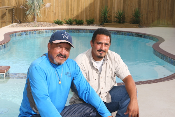 Noel Martinez (left) and his son Gabriel Martinez beside one of their most recent creations on Padre Island in Corpus Christi. Owner of Oscar’s Pools, Noel Martinez bought the company from his brother 25 years ago. Gabriel’s involvement keeps the family business tradition going. Photo by Carrie Robertson Meyer/Third Coast Photo