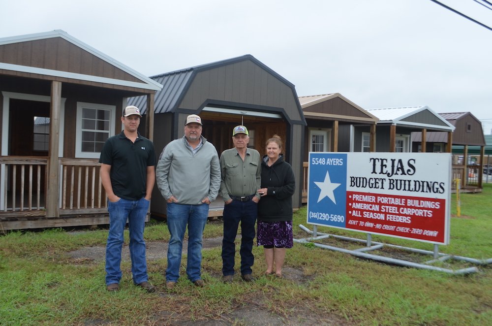 Josh Boyd (left), Steven Rives, and Kenneth and Joyce Rives in front of just a few of the sturdy, durable buildings they offer at Tejas Budget Buildings in Corpus Christi. Photo by Jane Kathleen Gregorio