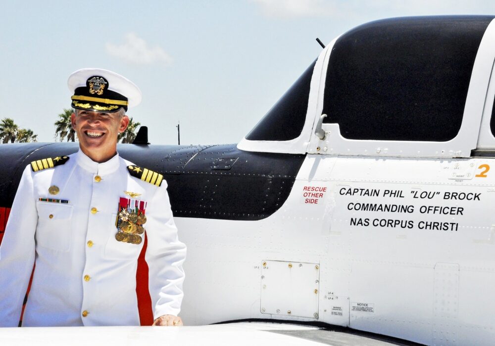 Capt. Philip Brock stands next to the T-34C aircraft that will bear his name throughout his tenure as commanding officer of Naval Air Station Corpus Christi. Brock assumed command of the South Texas naval air station during a change-of-command ceremony July 20. Photo by Jason Kucera, NASCC Public Affairs